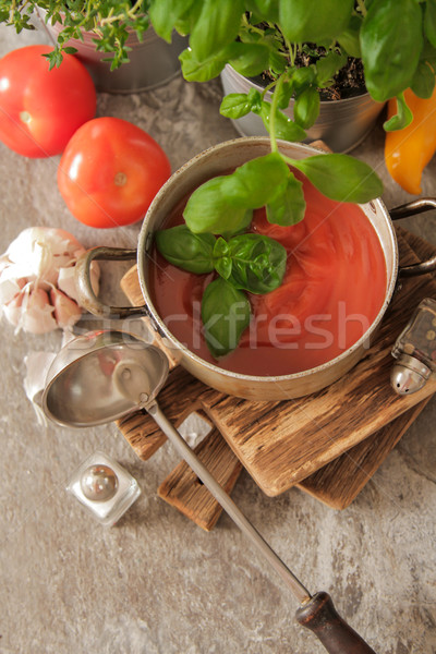tomato soup with basil in a pot on the marble Stock photo © Naltik