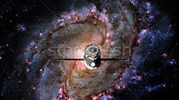 Spacecraft Progress orbiting the spiral galaxy. Stock photo © NASA_images