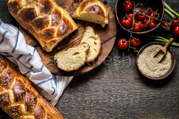 Challah is a Jewish bread to feast on wooden boards Stock photo © Natalya_Maiorova