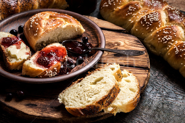 Challah is a Jewish bread to feast on wooden boards Stock photo © Natalya_Maiorova