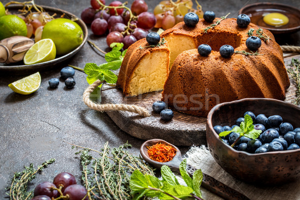 Cake baking with citrus and fresh blueberries, grapes and herbs Stock photo © Natalya_Maiorova