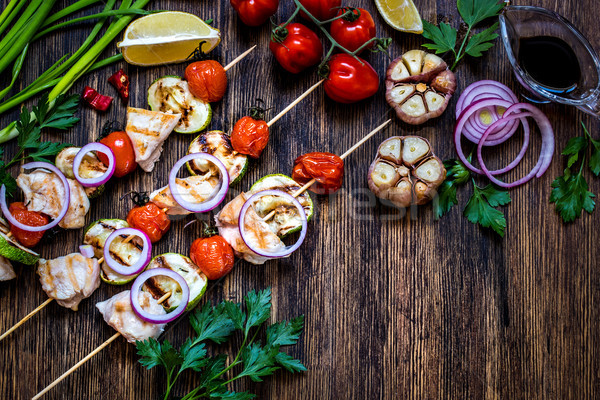 grilled chicken with zucchini, tomatoes, onions and herbs on wooden background Stock photo © Natalya_Maiorova