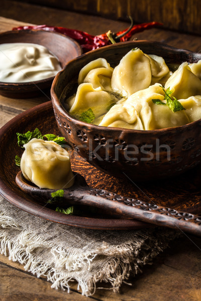 Russian dumplings with meat and broth in a rustic style Stock photo © Natalya_Maiorova