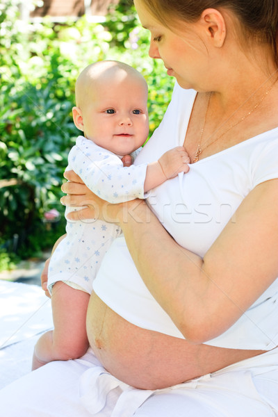 Stock photo: Pregnant woman with infant