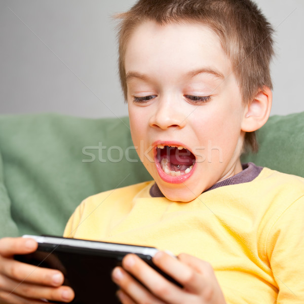 Boy playing game console Stock photo © naumoid