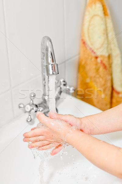 Little girl washing hands Stock photo © naumoid
