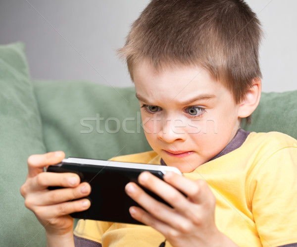 Boy playing game console Stock photo © naumoid