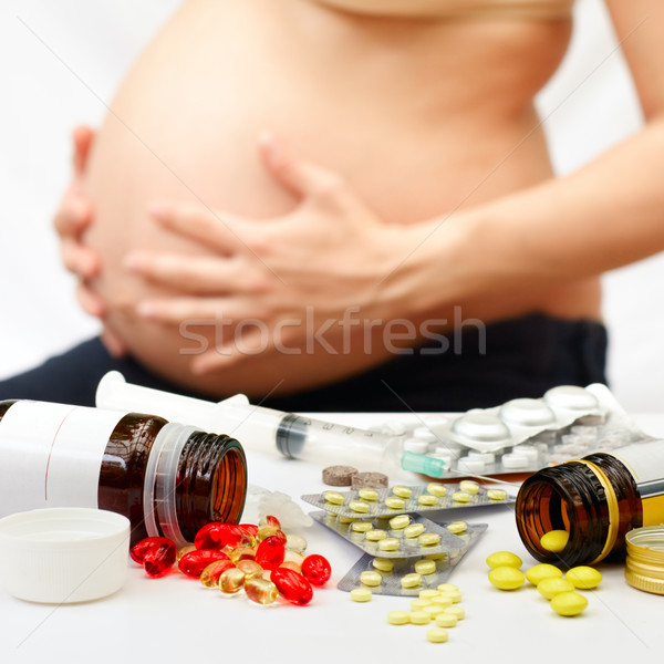 Terhesség citromsárga piros tabletták üvegek terhes nő Stock fotó © naumoid