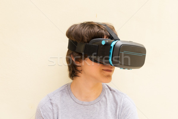Teenager wearing VR glasses Stock photo © neirfy