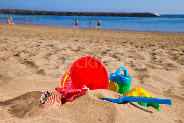 bucket with plastic beach toys in sand on sea shore Stock photo © neirfy