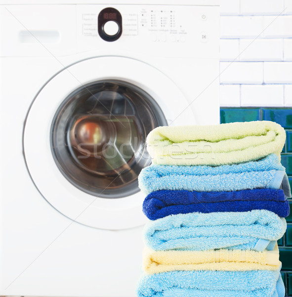 pile of clean towels with washing machine Stock photo © neirfy