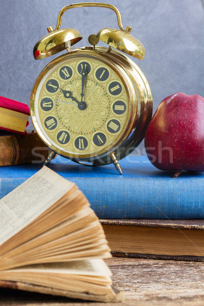 Stock photo: pile of books with clock