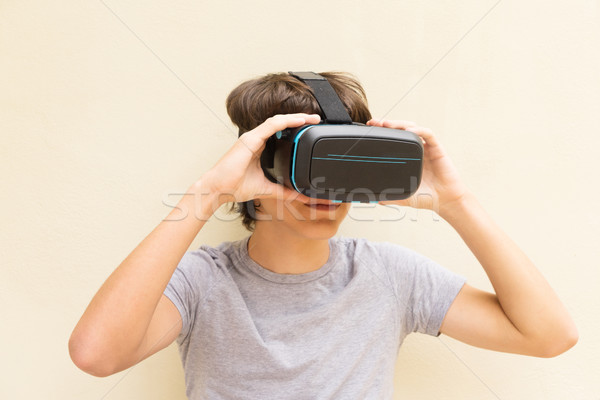 Teenager wearing VR glasses Stock photo © neirfy