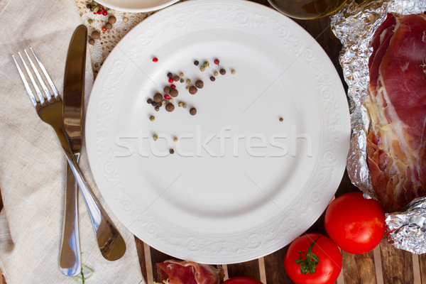 empty plate with tomatoes and jamon Stock photo © neirfy