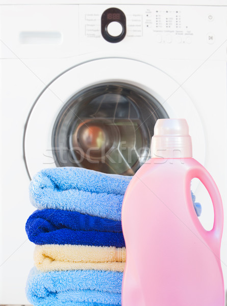 Stock photo: Towels with detergent and washing machine