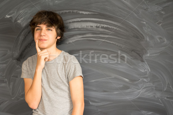 Stock photo: Boy writting on black board