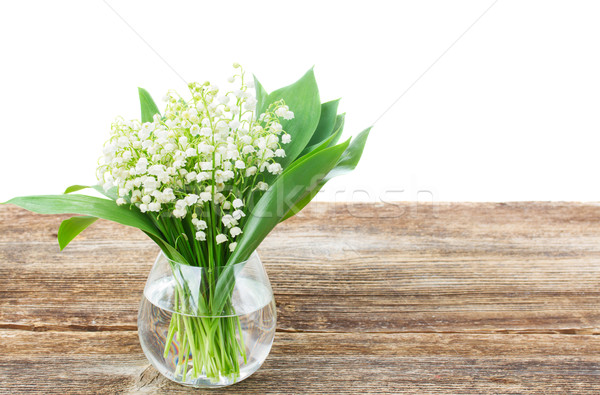 Stock photo: Lilly of valley on wood 