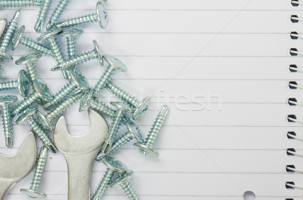 disassembled screws and wrenches on paper Stock photo © neirfy