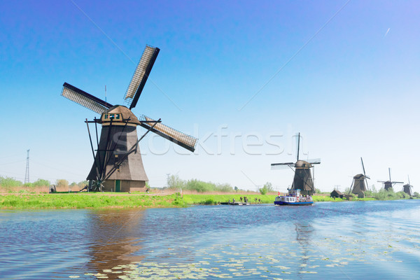 dutch windmill over river waters Stock photo © neirfy