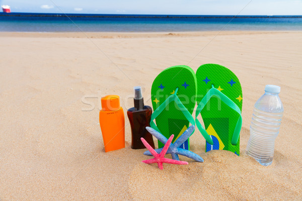 sandals and  bottle of water on sandy beach Stock photo © neirfy