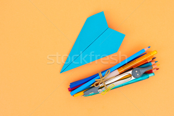 Zurück in die Schule Schulbedarf blau Papier Flugzeug orange Stock foto © neirfy