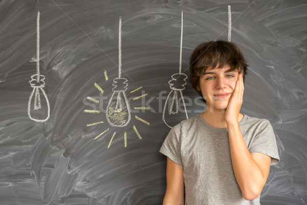 Teenager boy getting an idea Stock photo © neirfy