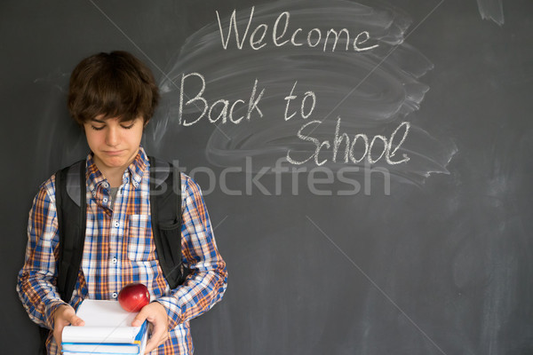 Stock photo: Boy and back to school black board