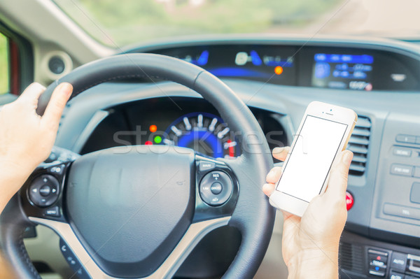 driving car and phone Stock photo © neirfy