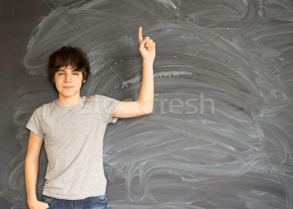 Boy writting on black board Stock photo © neirfy