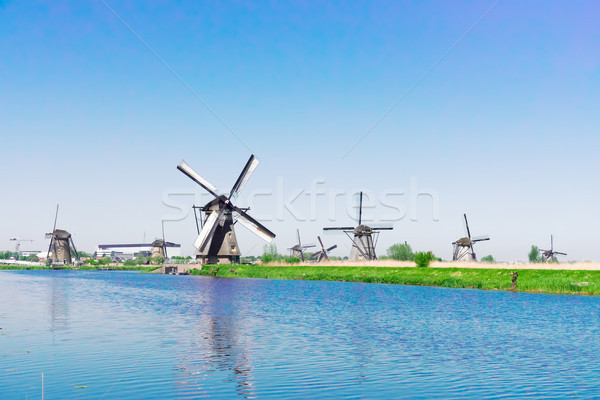 Stock photo: dutch windmill over river waters