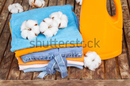 orange bottle of detergent and cotton clothes Stock photo © neirfy