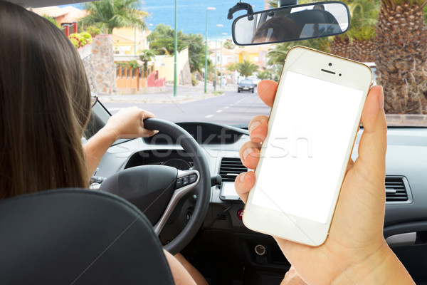 Stock photo: female hand holding a phone with empty  screen