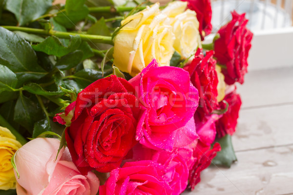 Stock photo: yellow and pink  roses  on table