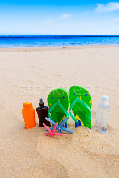 sandals and  bottle of water on sandy beach Stock photo © neirfy