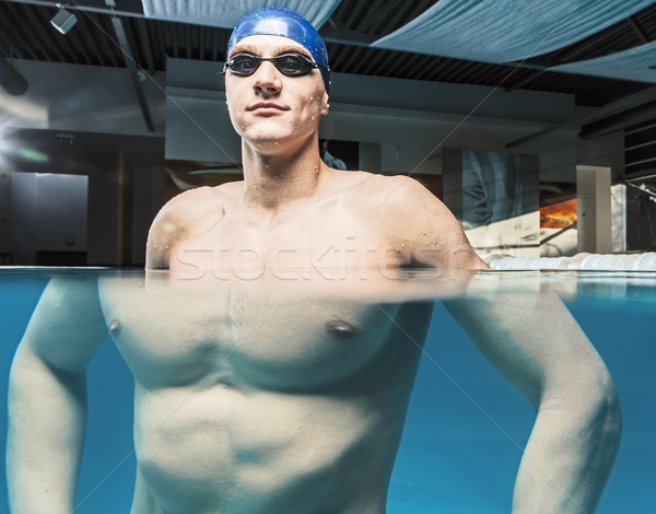 Muscular young man in blue cap in swimming pool Stock photo © Nejron