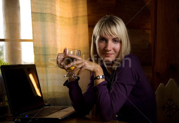 Blond girl drinks tee after working on computer Stock photo © Nejron