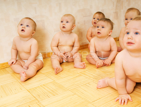 Group of adorable toddlers sitting on a floor Stock photo © Nejron