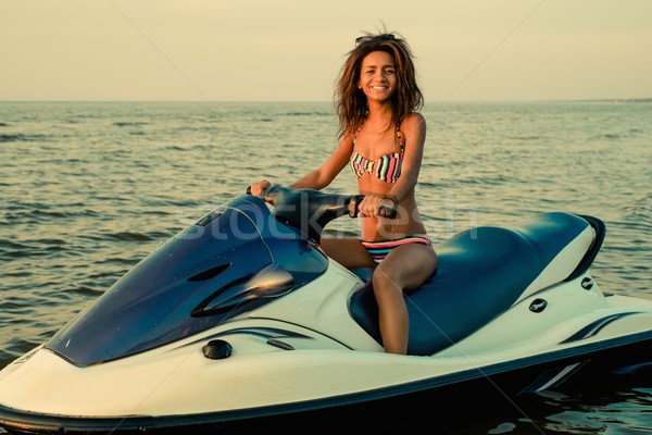 African-american girl sitting on a jet ski Stock photo © Nejron