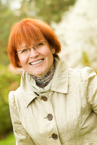 Beautiful smiling middle-aged woman outdoors Stock photo © Nejron