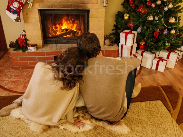 Pár kandalló karácsony díszített házbelső nő Stock fotó © Nejron