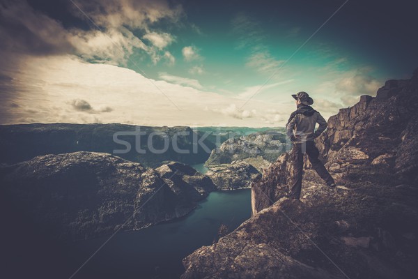 Man hiker looking over fjord panorama Stock photo © Nejron