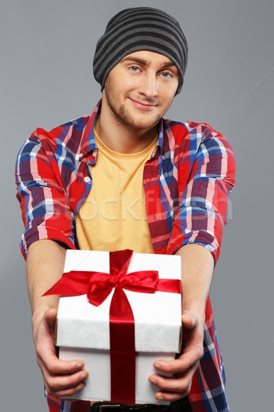 Stylish young man in shirt and beanie hat with gift box Stock photo © Nejron