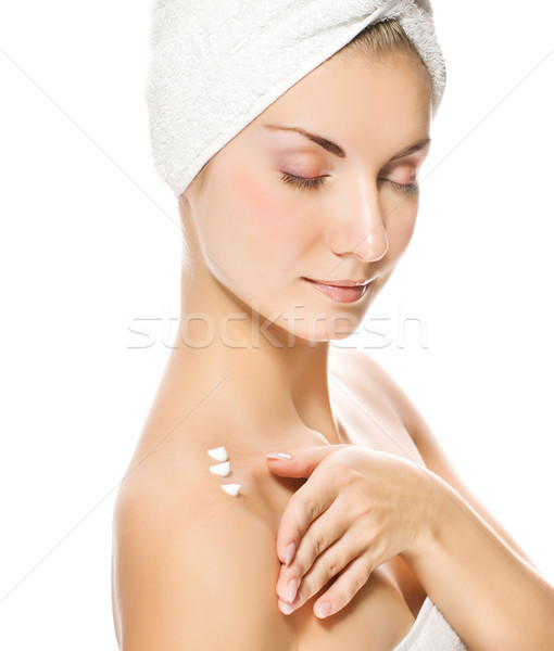Young lovely lady applying moisturizer to her skin after shower Stock photo © Nejron