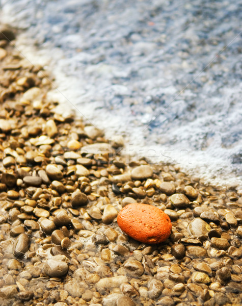 Ocean wave washes stone beach Stock photo © Nejron