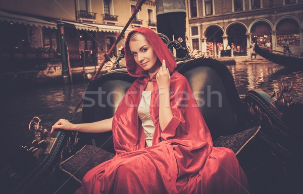 Beautiful woman in red cloak riding on gondola Stock photo © Nejron