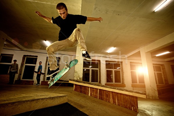 Young man performing a stunt in a skatepark Stock photo © Nejron