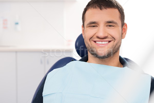 Smiling young man at dentist's surgery Stock photo © Nejron