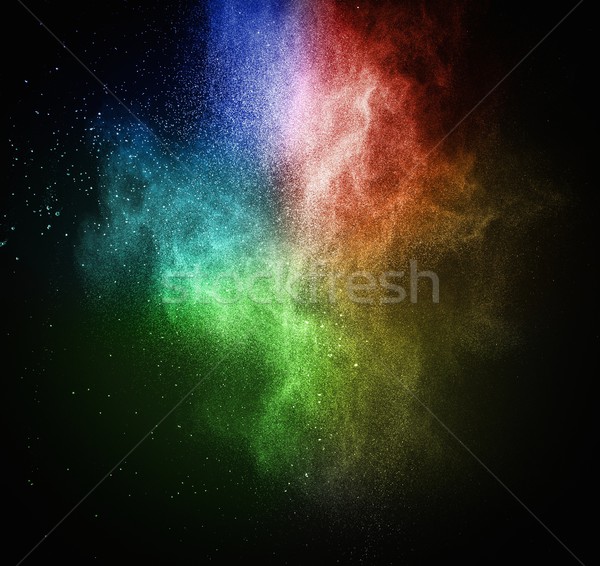 Stock photo: Colourful powder exploding isolated on black
