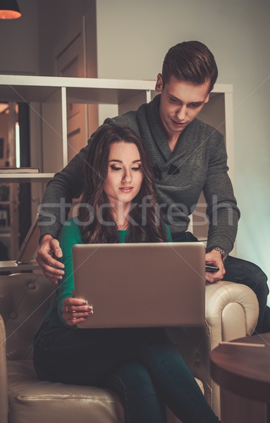 Young couple with laptop  behind table Stock photo © Nejron