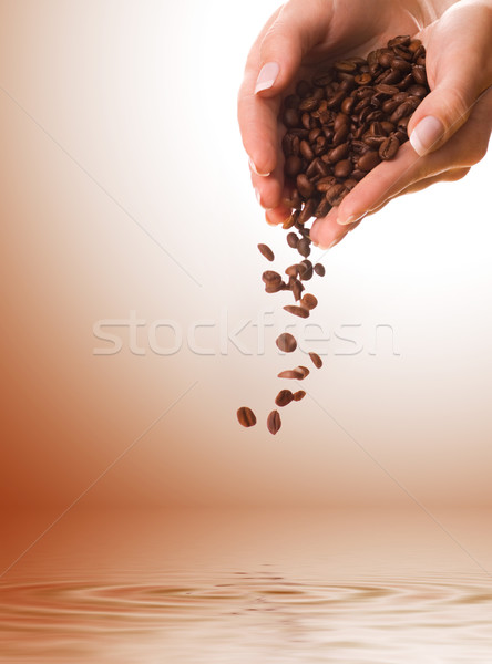 Hands with coffee beans Stock photo © Nejron